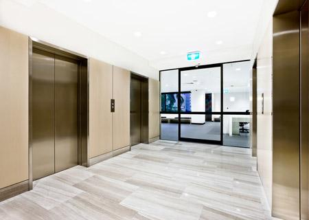 stainless steel elevators outside an office brassco cleans